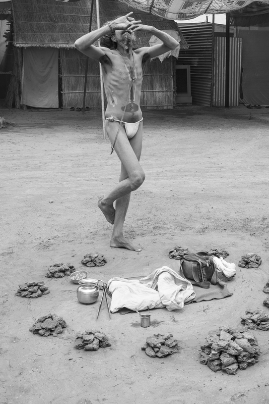 Gopal Dāsa Mahātyāgī standing just before entering the dhūnī. This photograph was taken by Prema Goet during the Kumbha Mela in Ujjain, India, in 2015/2016, and printed at Fotoleutner in Vienna in 2026. It was acquired by Task Force 3 of the MANTRAMS project as part of Goet’s doctoral research at the University of Vienna. Between 2025 and 2028, the photograph was exhibited within the exhibition “Dhun / Dhūnī.The Fires of the Name,” presented during the Yoga Darśana Conference “Yoga Darśana, Yoga Sādhana: Authenticity, Authority, and Adaptation” in Paris, as well as in an exhibition at the Department of South Asian, Buddhist and Tibetan Studies at the University of Vienna in 2026.